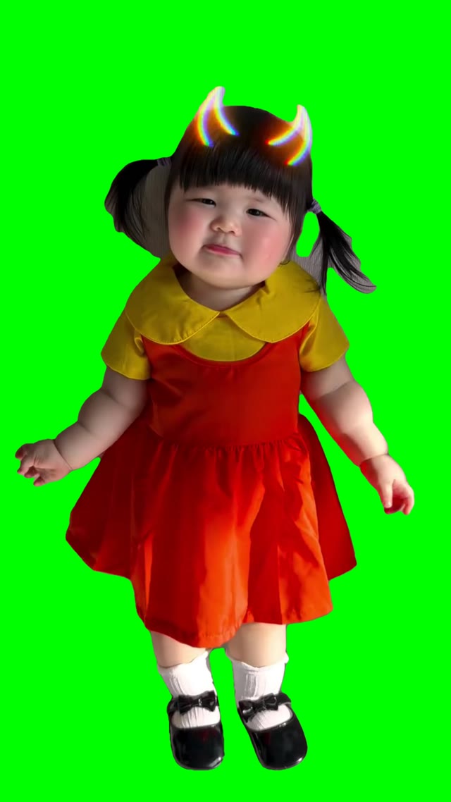 Girl dressed as Doll in Squid Game Green light Red light green screen