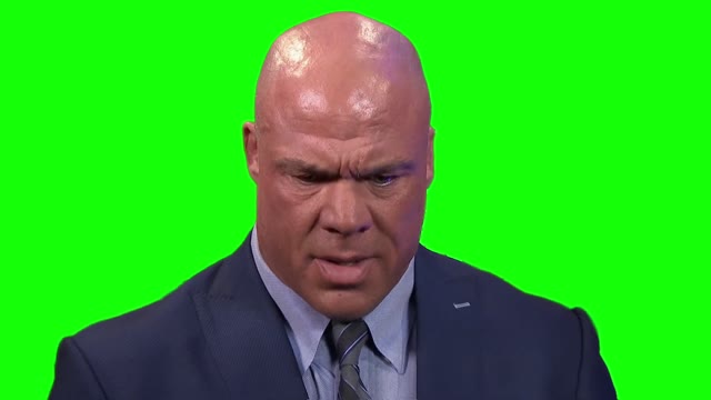 Kurt Angle looking at phone green screen