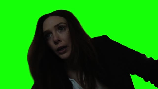 Scarlet Witch Wanda stares into the camera green screen